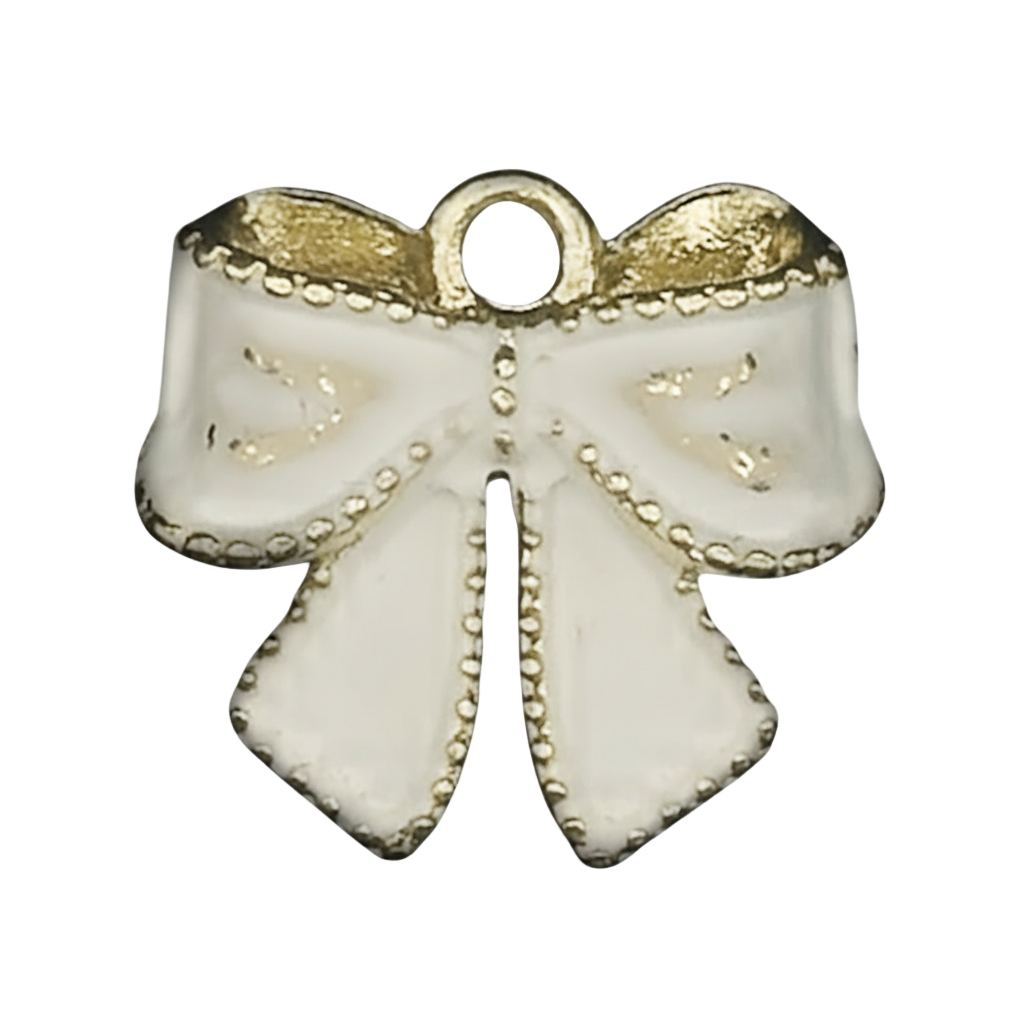 close-up of a white enamel bow charm with gold accents on a black background