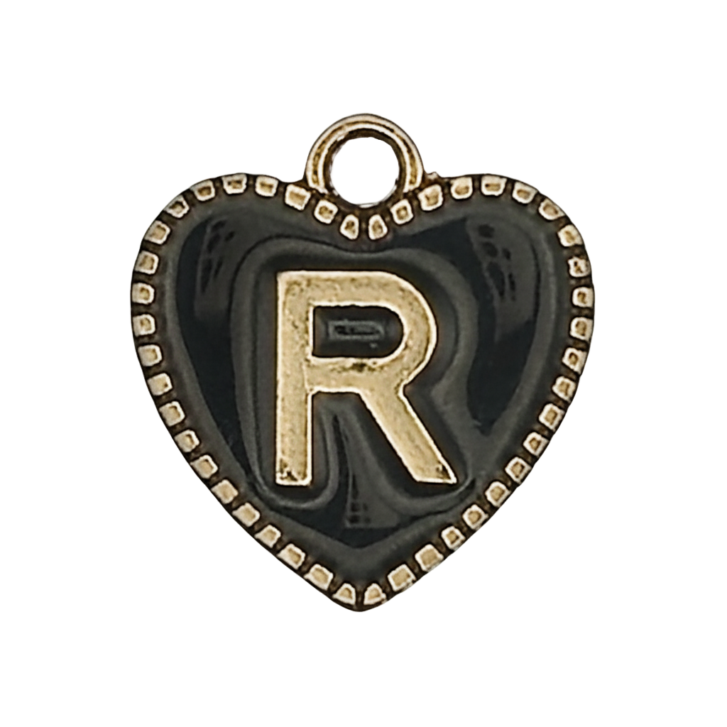 close-up of black heart charm with gold letter R and dotted border