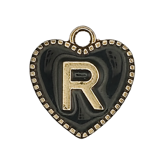 close-up of black heart charm with gold letter R and dotted border