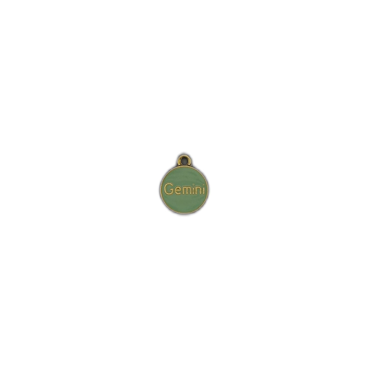 small green round charm reading 'Gemini' with gold trim on black background