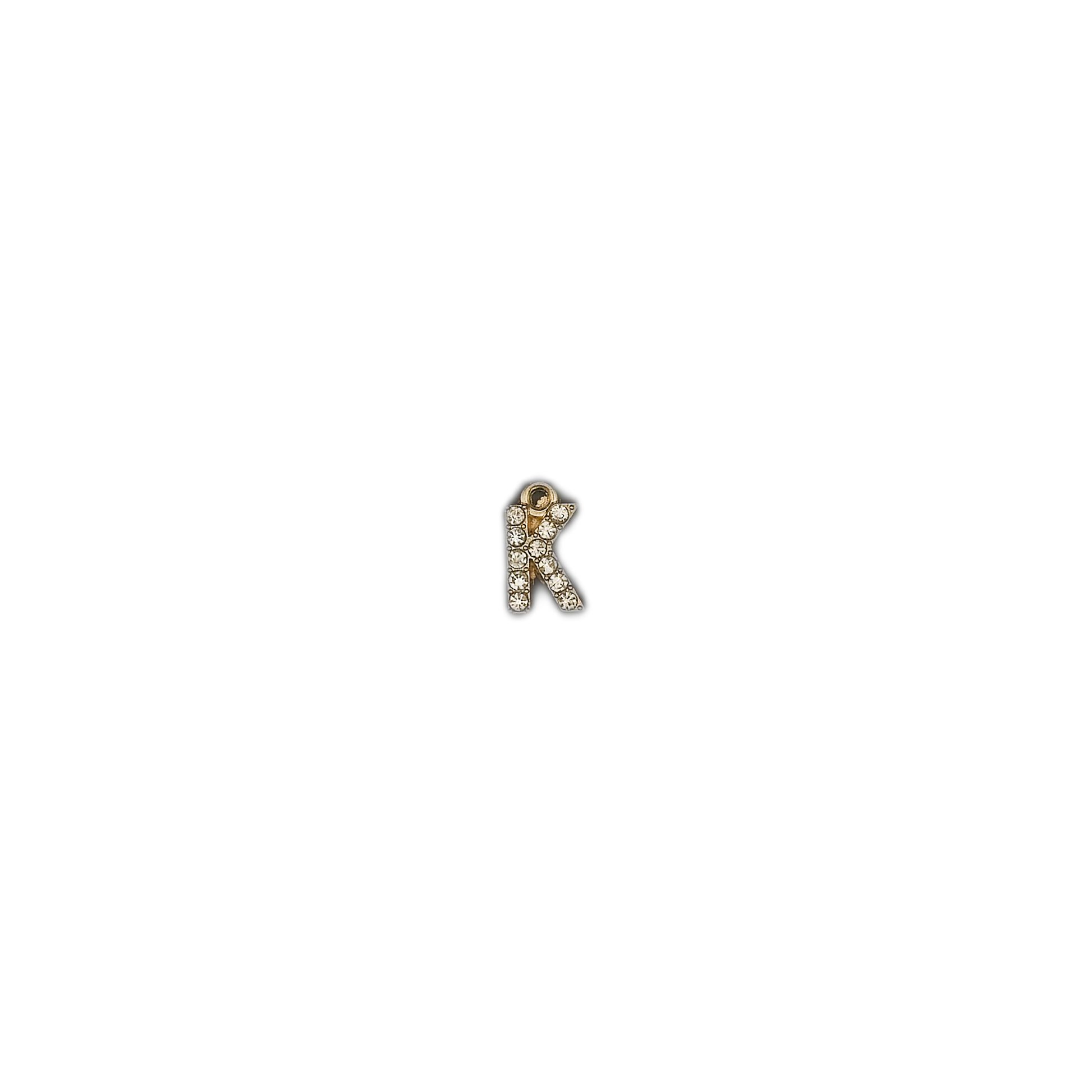 small letter K charm with clear stones centered on black background
