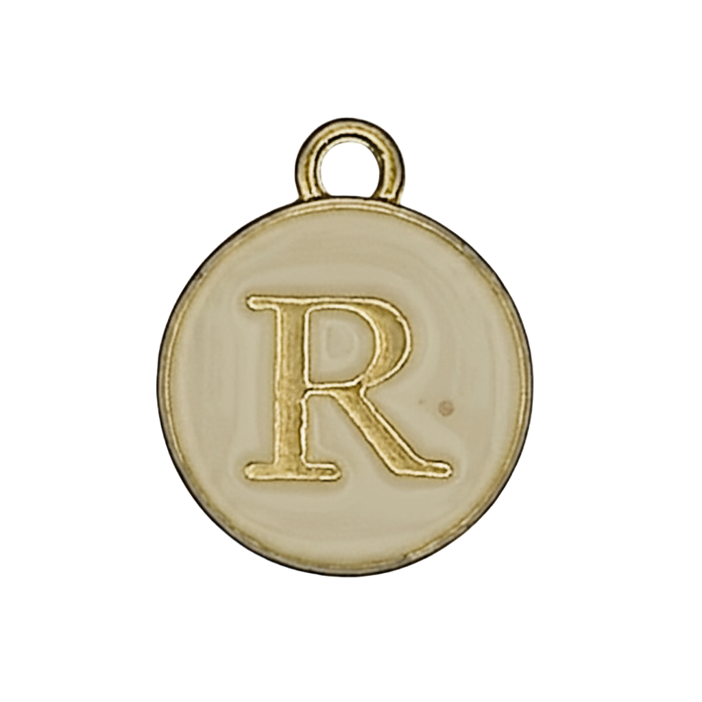 Close-up of a round gold-tone letter R charm on an ivory disk.