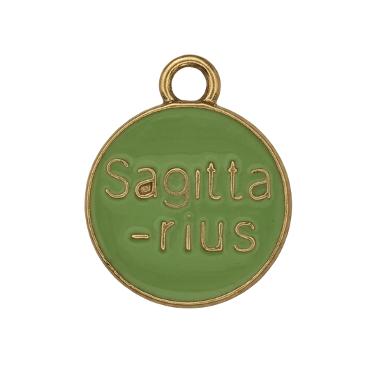 close-up of round green enamel charm with gold 'Sagittarius' text