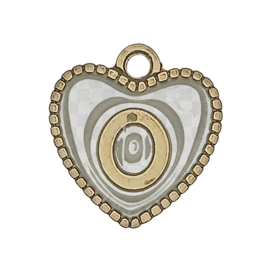 close-up of black and gold heart charm with eye motif