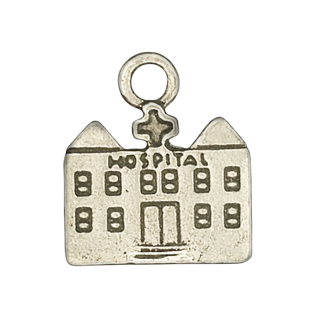 close-up of small silver hospital building charm on black background