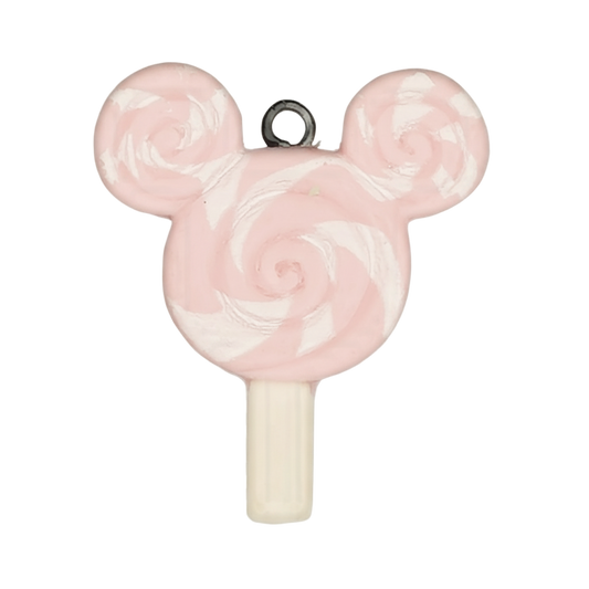 close-up of pink and white swirl lollipop mouse-head charm on black background