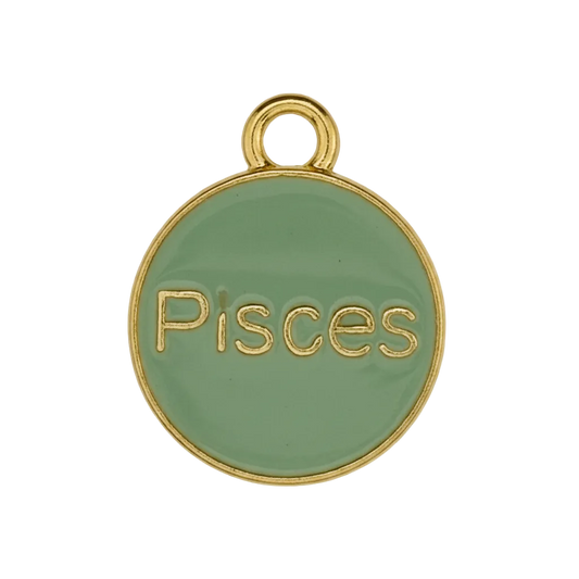 close-up of a small round green enamel charm with gold text reading Pisces