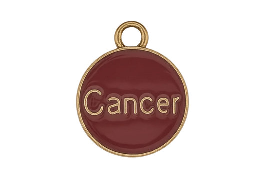 red round charm with gold rim and the word "Cancer"