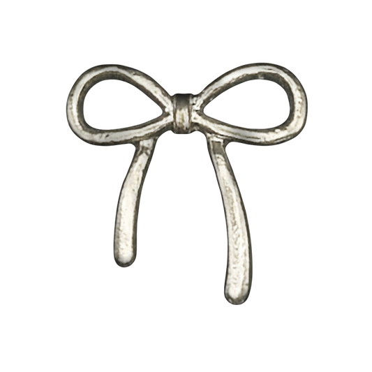 close-up of a small silver bow-shaped charm on a black background