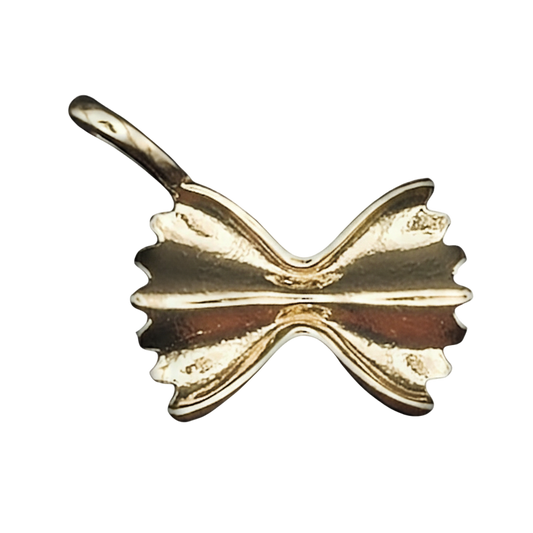 close-up of gold-tone farfalle pasta charm on black background