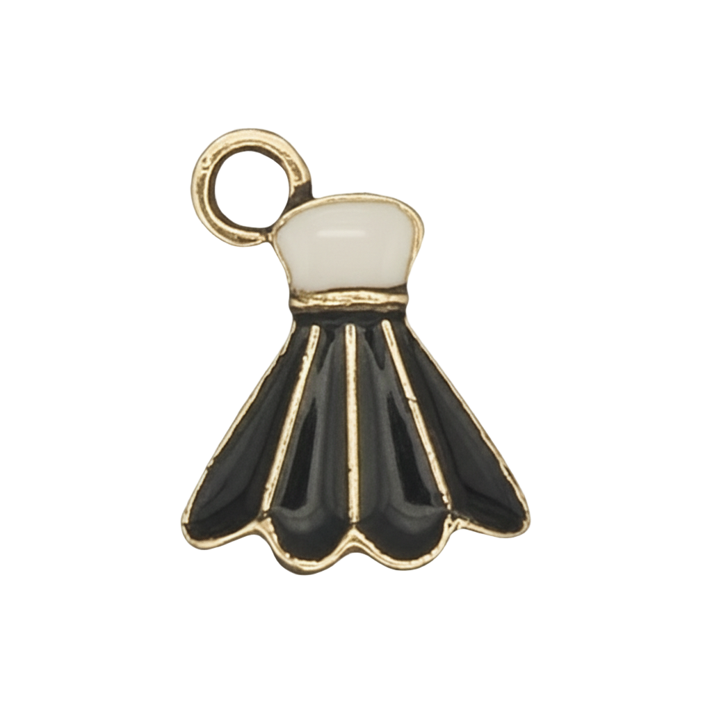 close-up of black and white enamel shuttlecock charm with gold outline on a black background