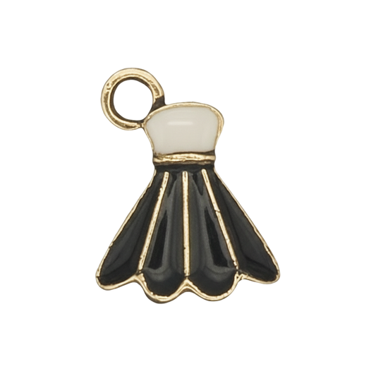 close-up of black and white enamel shuttlecock charm with gold outline on a black background