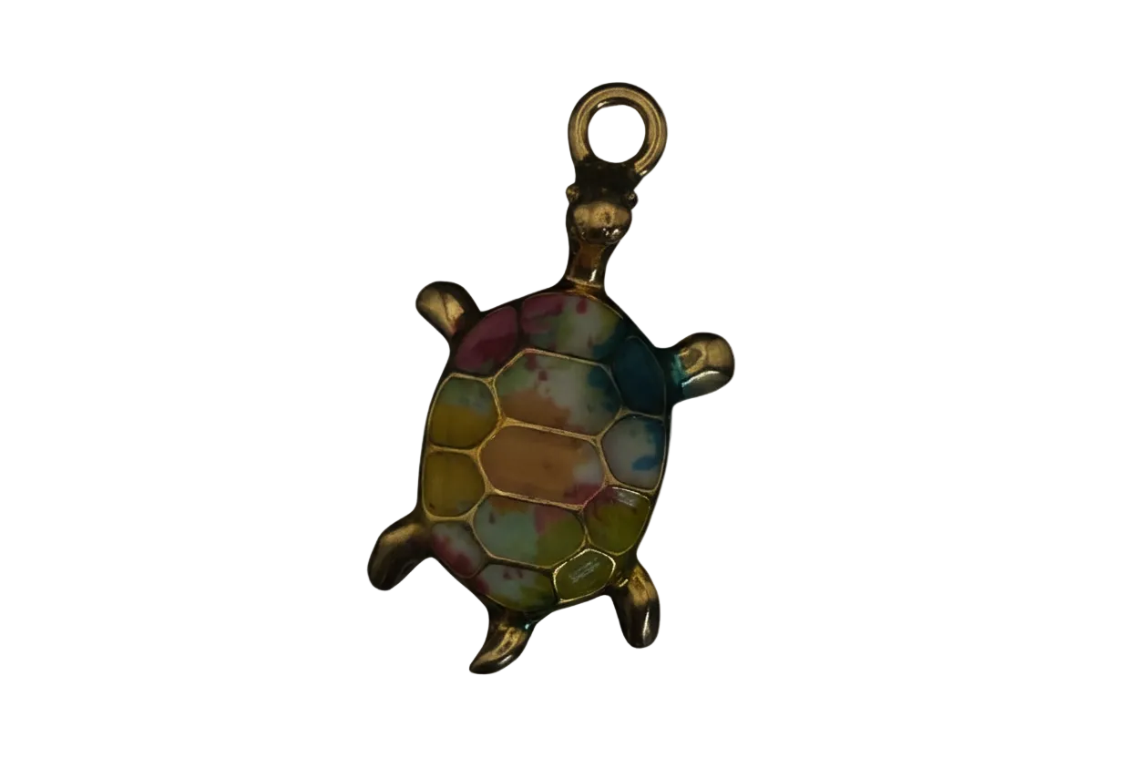 close-up of a small gold-tone turtle charm with multicolor enamel shell on black background