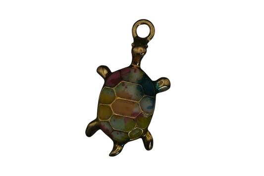 close-up of a small gold-tone turtle charm with multicolor enamel shell on black background