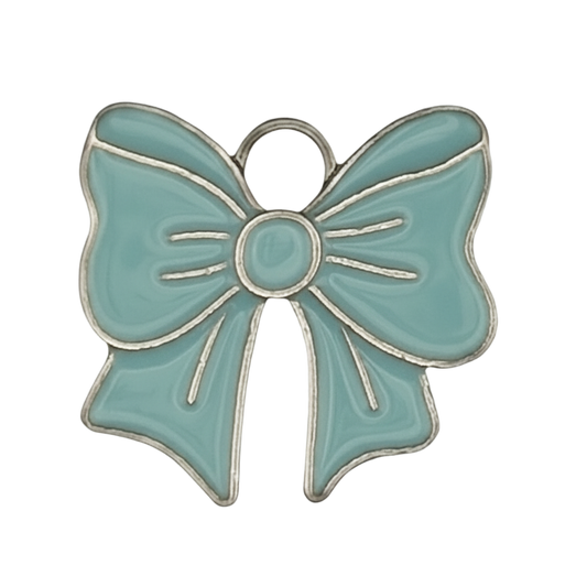 close-up of teal enamel bow charm with silver outline on black background