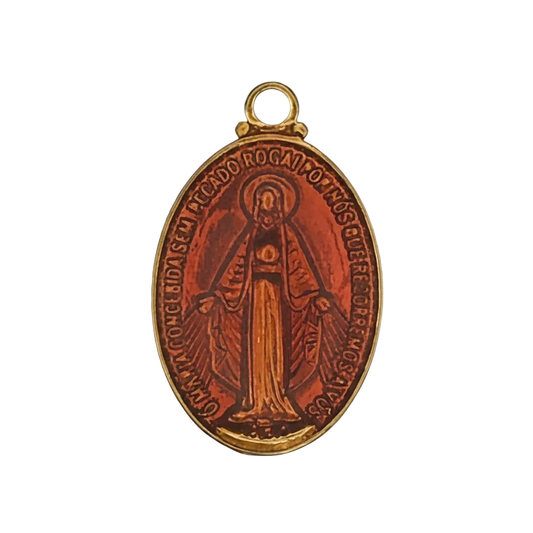 Close-up of an oval red enamel miraculous medal charm with a gold-tone edge and a figure of Mary.
