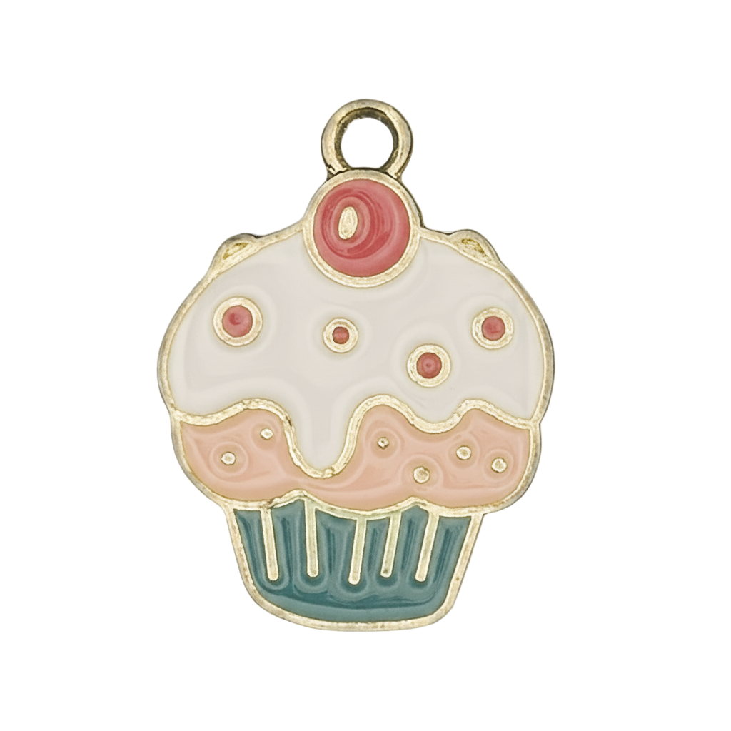 close-up of enamel cupcake charm with white icing, pink dots, and teal wrapper