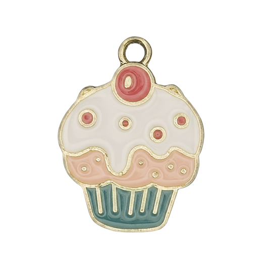 close-up of enamel cupcake charm with white icing, pink dots, and teal wrapper
