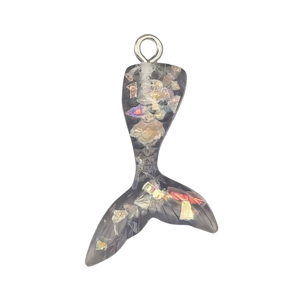 close-up mermaid tail charm in black resin with multicolor flakes on black background