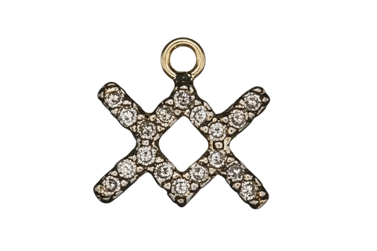 close-up of a small gold-tone XO charm with clear stones on a black background