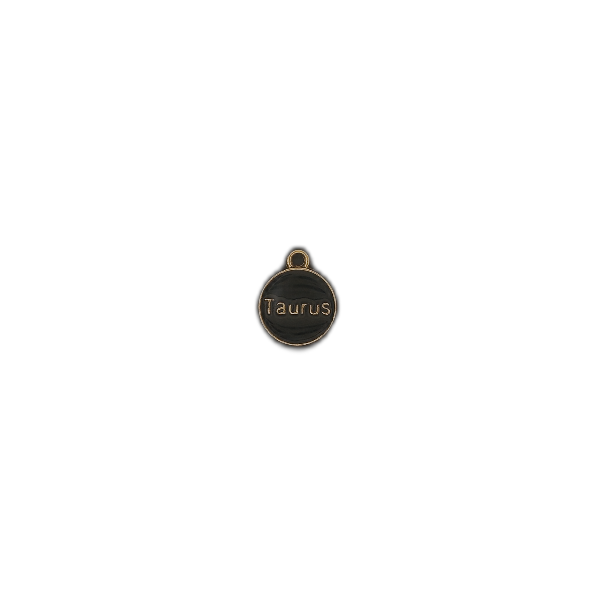 small round black and gold charm with the word Taurus