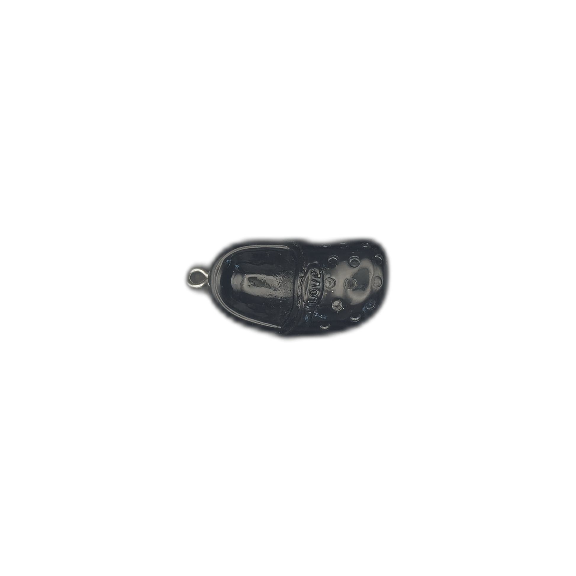 black clog shoe charm centered on dark background