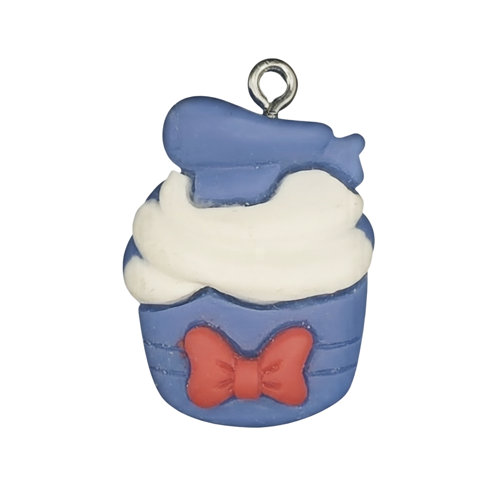 close-up of blue cupcake charm with white frosting and red bow on black background