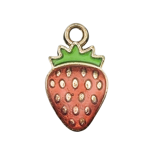 close-up of strawberry enamel charm with green top and gold outline on black background