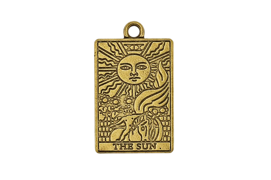 close-up of rectangular gold 'the sun' tarot charm