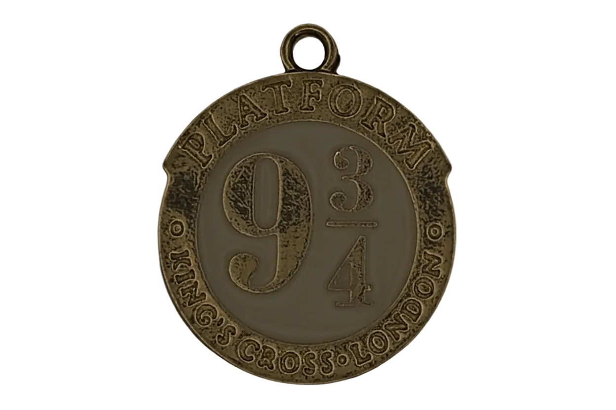 close-up of round gold-tone charm reading 'Platform 9 3/4 King's Cross London'