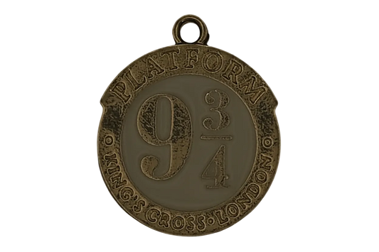 close-up of round gold-tone charm reading 'Platform 9 3/4 King's Cross London'