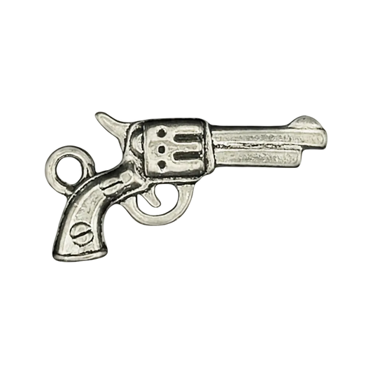 close-up of silver revolver charm on black background