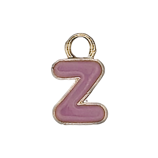 close-up of a small pink enamel letter Z charm with gold outline on a black background