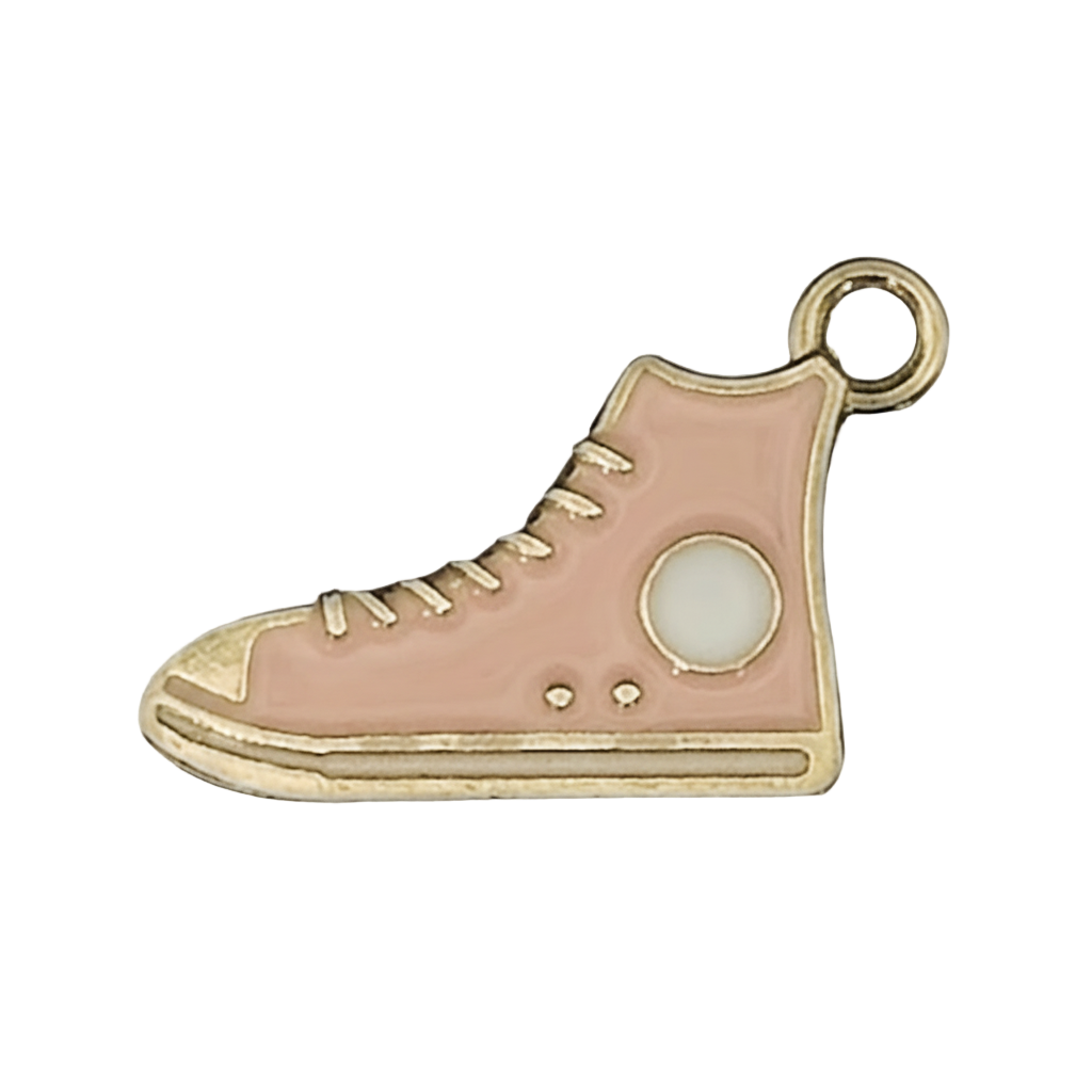 close-up of pink enamel high-top sneaker charm with gold outline and white patch