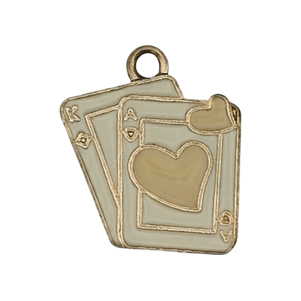 Close-up of a gold-tone enamel charm shaped like overlapping playing cards with heart suit.