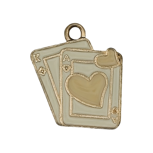 Close-up of a gold-tone enamel charm shaped like overlapping playing cards with heart suit.