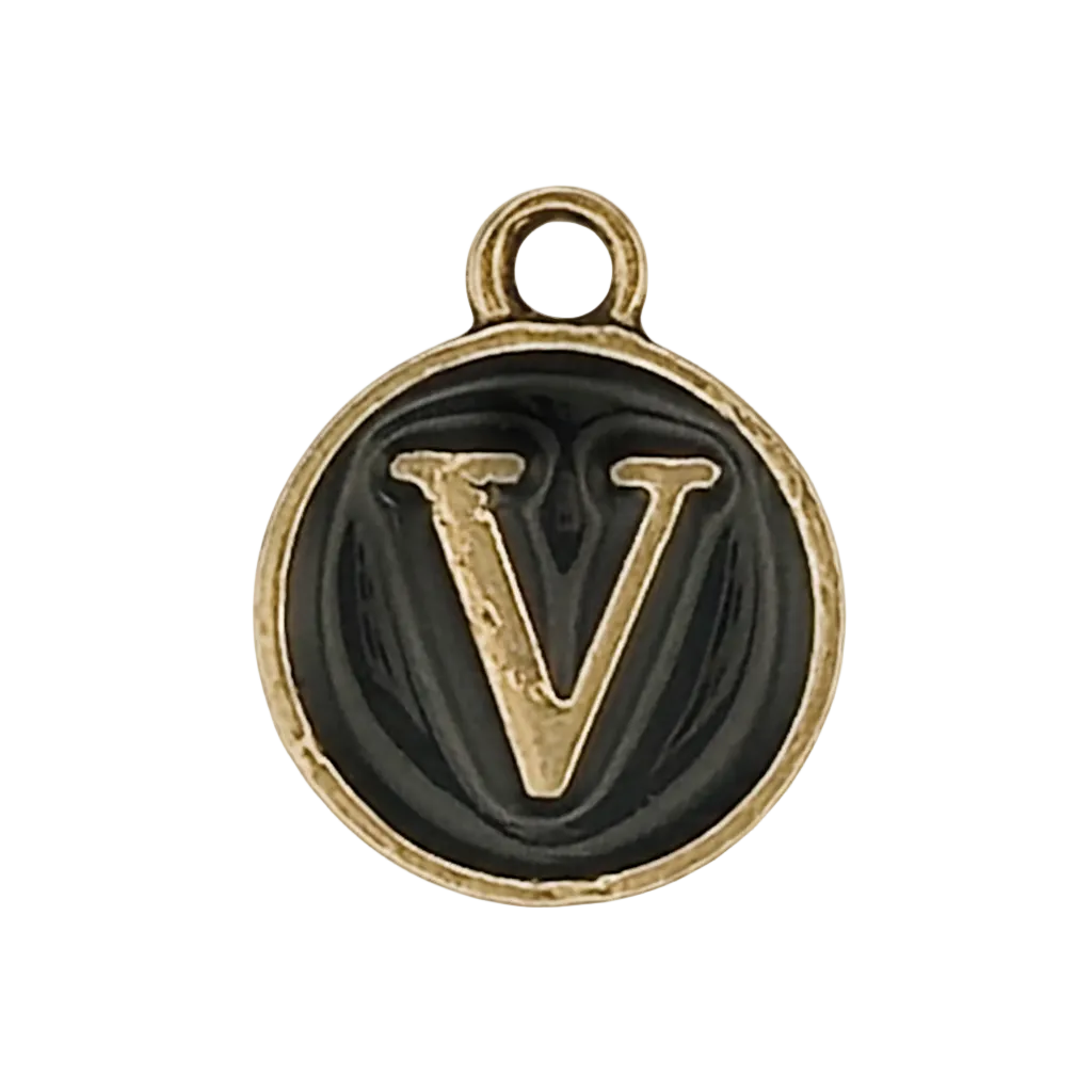 close-up of round black charm with raised gold-tone letter V