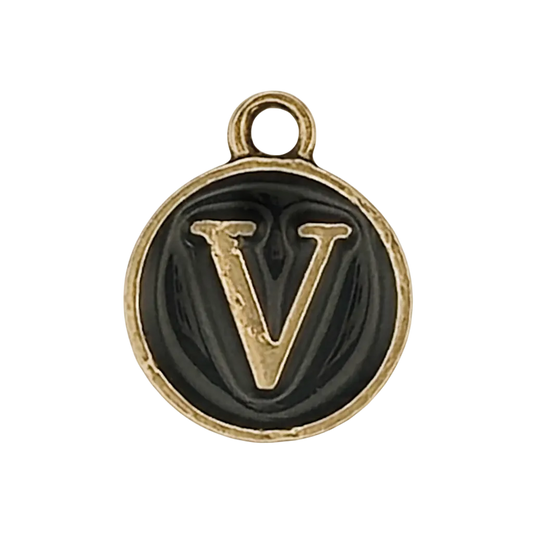 close-up of round black charm with raised gold-tone letter V