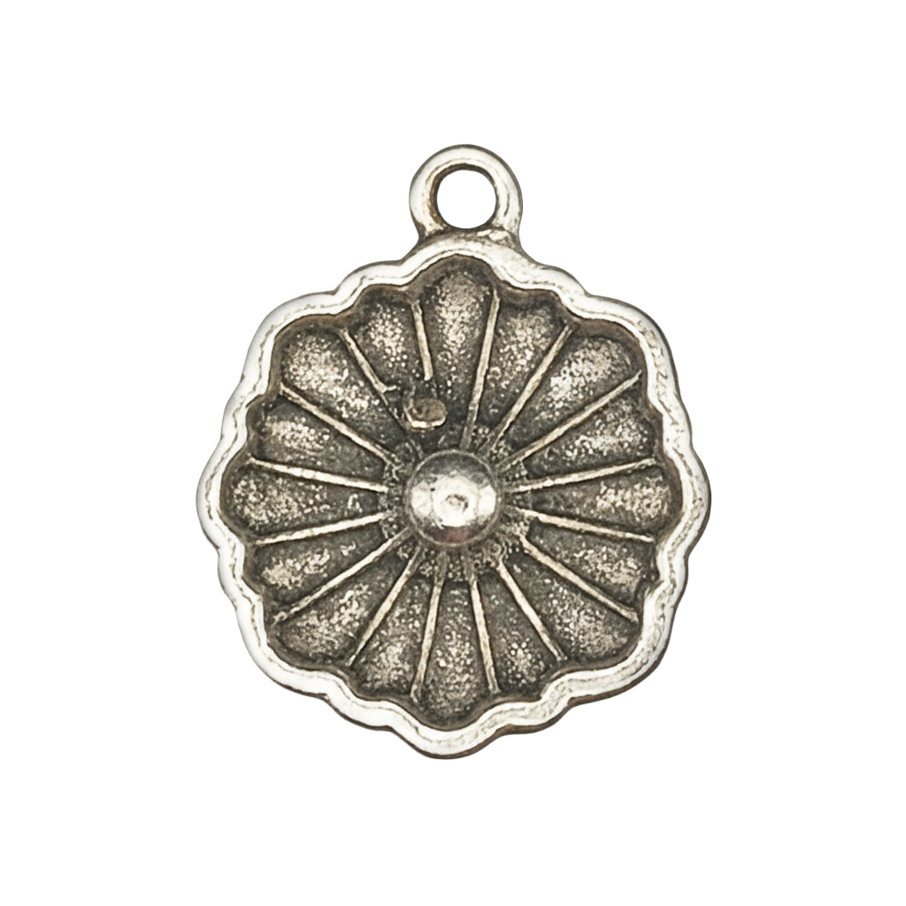 close-up of a round antique silver flower charm with radiating petals on a black background