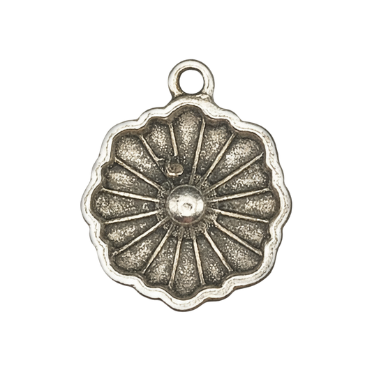 close-up of a round antique silver flower charm with radiating petals on a black background
