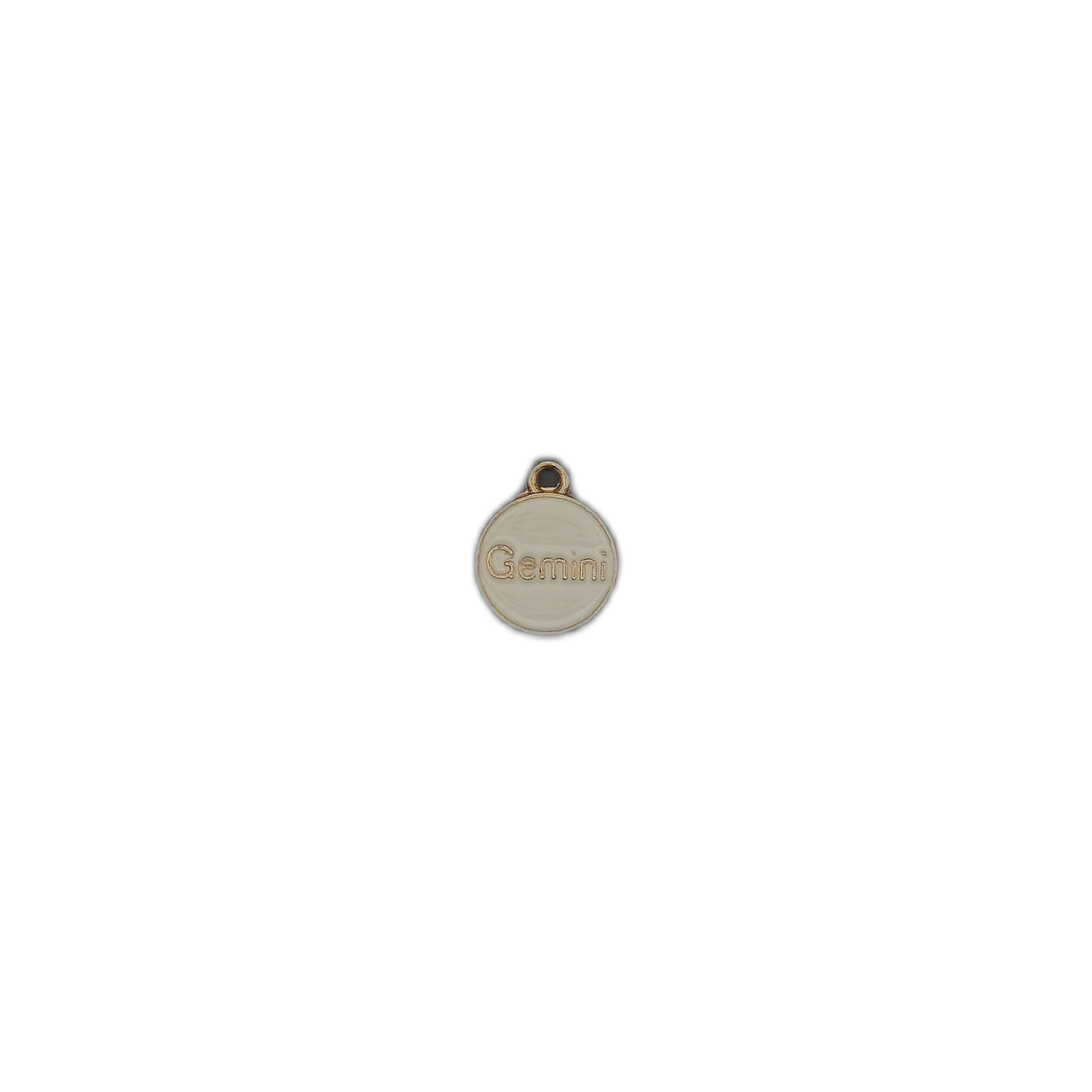 small round cream and gold Gemini charm centered on black background