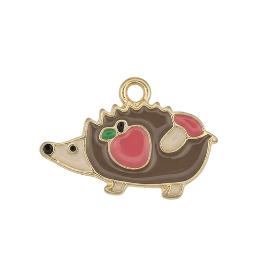 close-up of gold-tone enamel hedgehog charm on black background