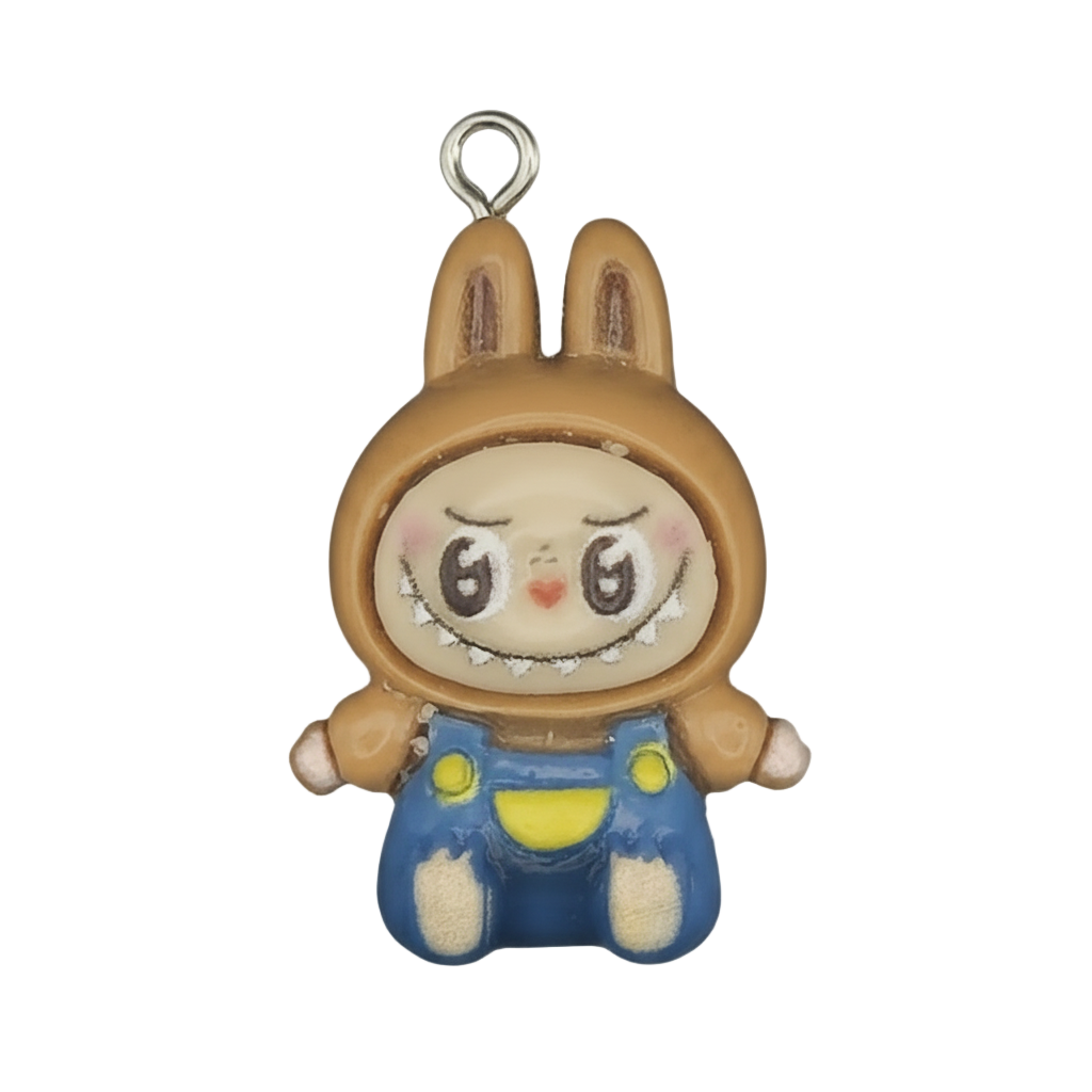 close-up of charm showing character in brown bunny hood with blue overalls