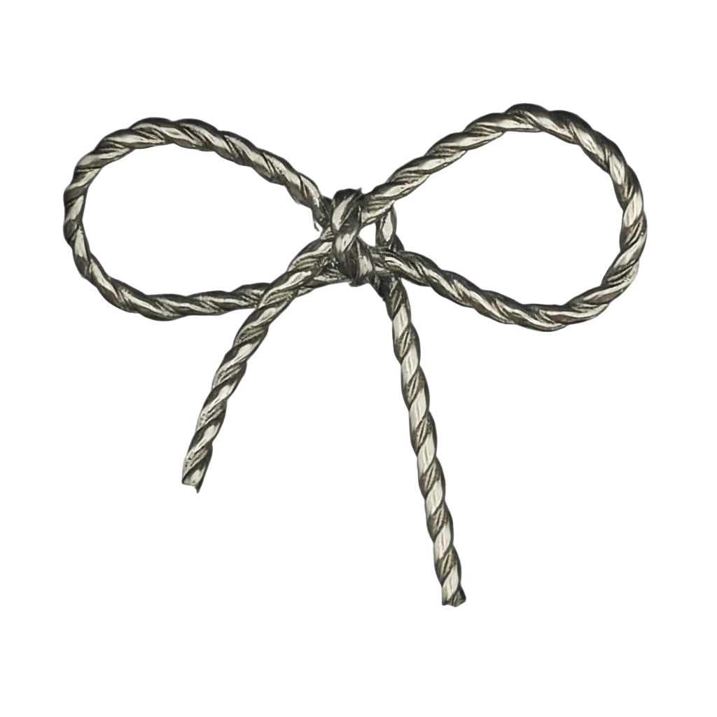 close-up of silver rope-textured bow charm on black background