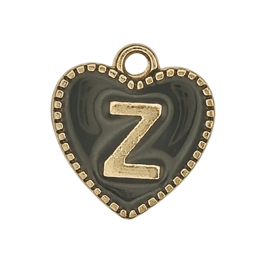 close-up of heart-shaped black charm with gold letter Z and dotted border