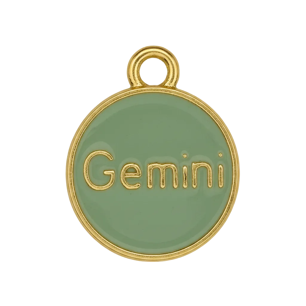 close-up of green round Gemini charm with gold edge