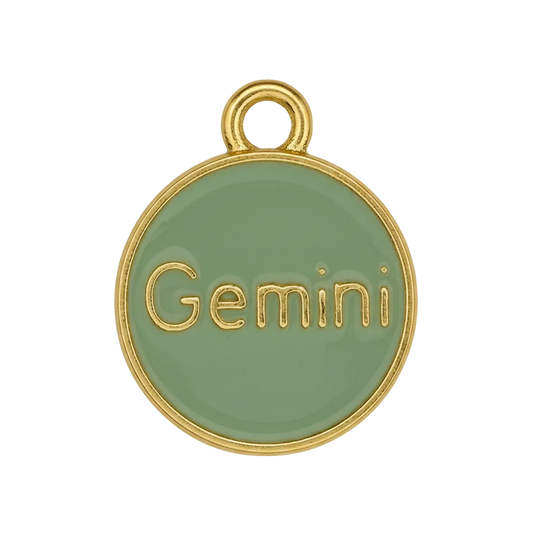 close-up of green round Gemini charm with gold edge