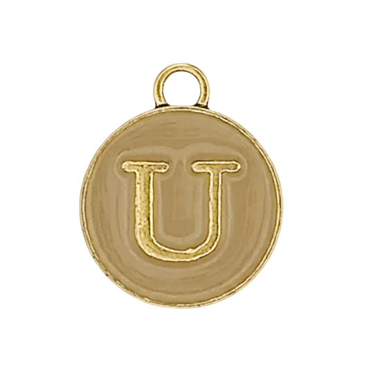 Close-up of a round gold-tone charm with the letter U.