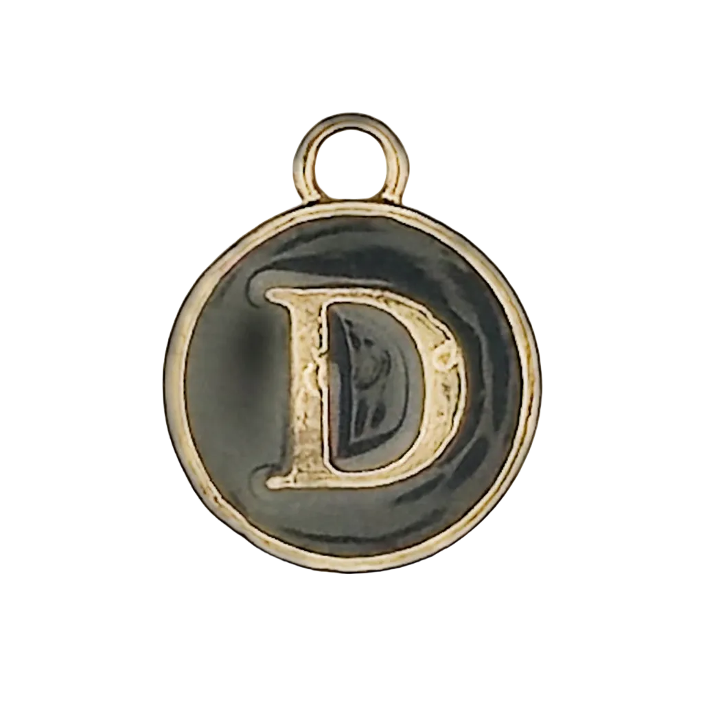 close-up of round black enamel charm with gold letter D