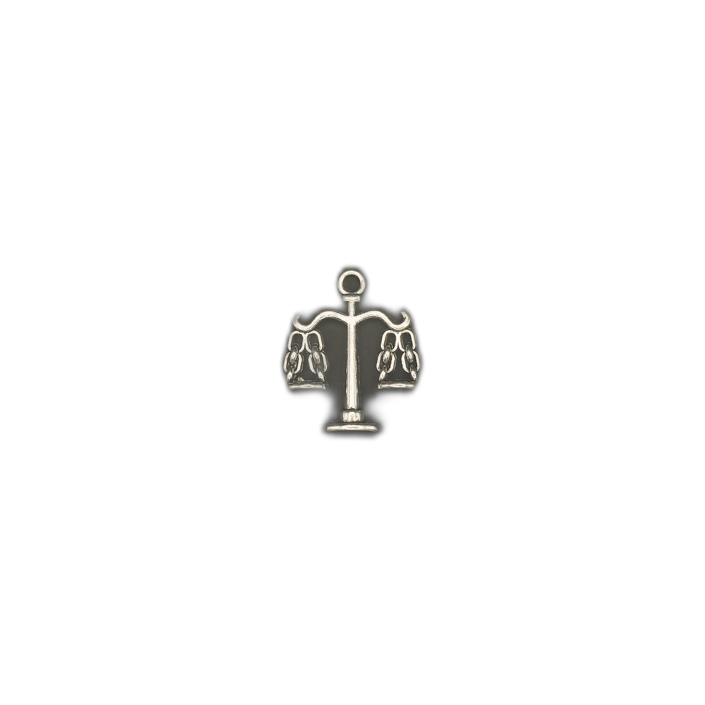 small silver-tone scales charm centered on black background